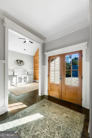 a bedroom with a large bed and wooden floor