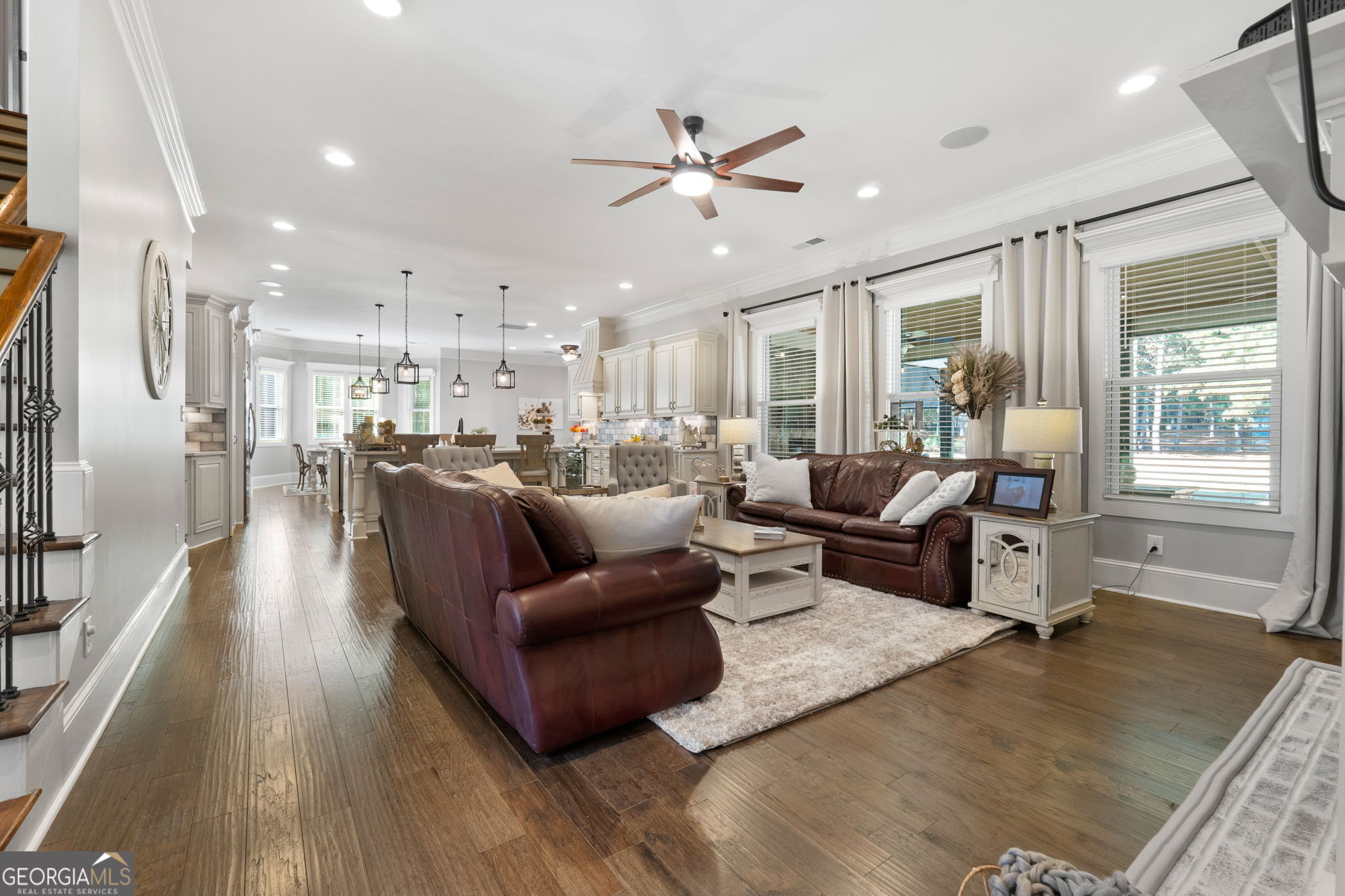 173 Dolly Nixon Road Senoia, GA 30276 - Photo 30 of 105 a living room with furniture kitchen area and a wooden floor