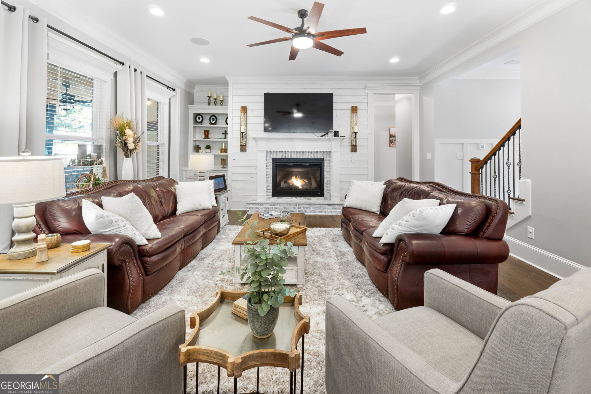 173 Dolly Nixon Road Senoia, GA 30276 - Photo 33 of 105 a living room with furniture a flat screen tv and a fireplace