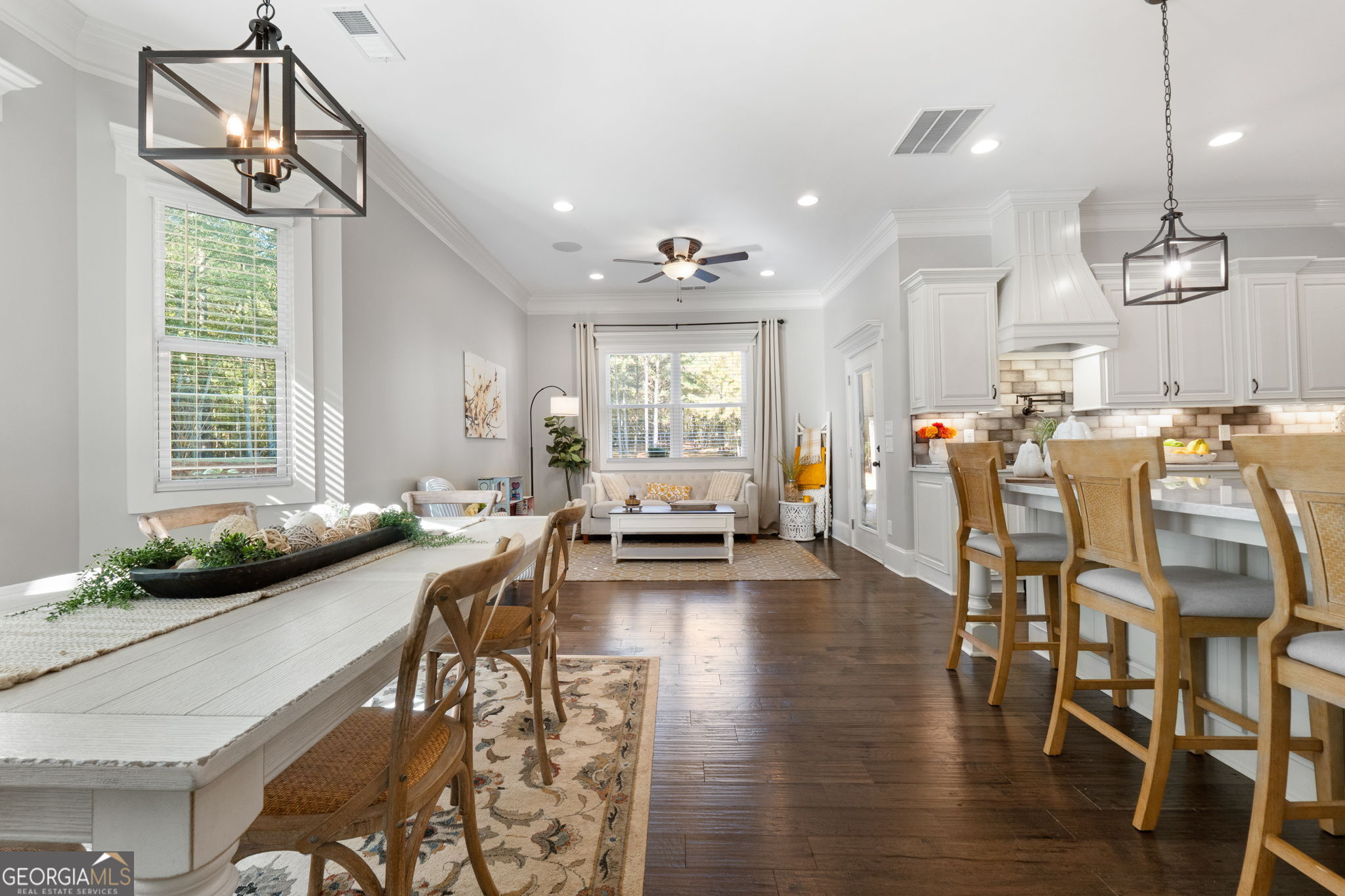 173 Dolly Nixon Road Senoia, GA 30276 - Photo 45 of 105 a view of a dining room and livingroom with furniture wooden floor a chandelier