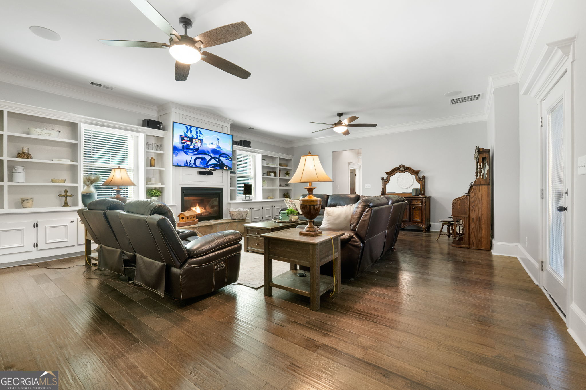 173 Dolly Nixon Road Senoia, GA 30276 - Photo 54 of 105 a living room with furniture a fireplace and a flat screen tv