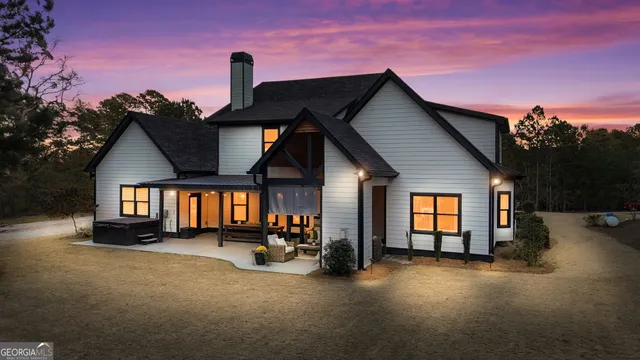 a house with potted plants in front of door