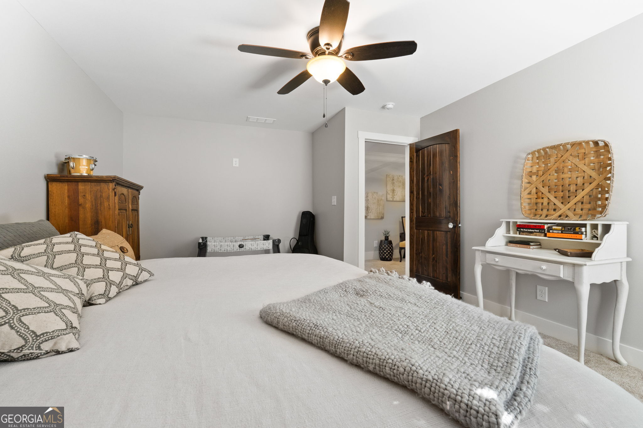 173 Dolly Nixon Road Senoia, GA 30276 - Photo 76 of 105 a bedroom with a bed and a chandelier