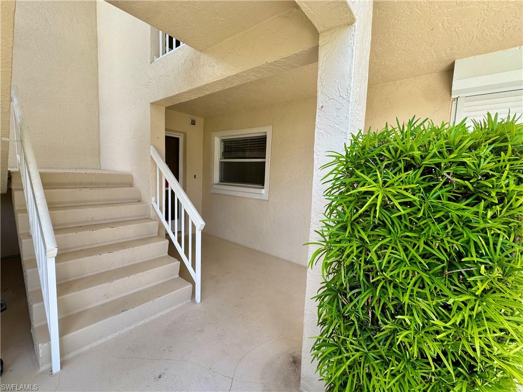 661 Squire Circle, Unit 101 Naples, FL 34104 - Photo 23 of 25 a view of entryway with stairs