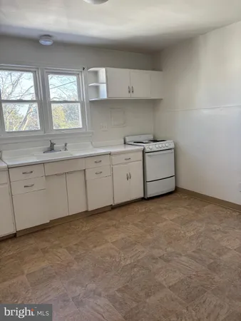 a kitchen with white cabinets and a sink