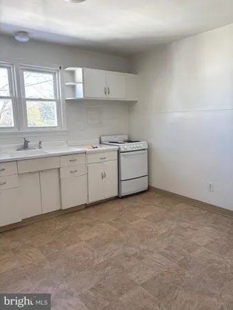 a kitchen with cabinets a sink and appliances