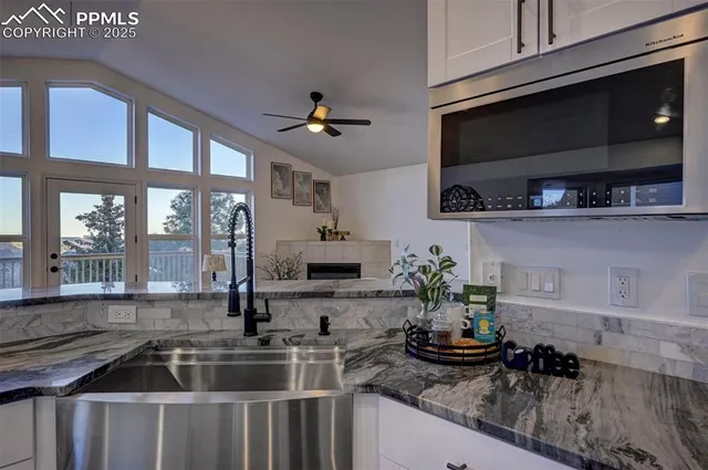 a kitchen with a sink and potted plant