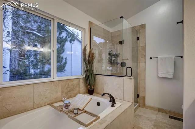 a bathroom with a tub sink and mirror