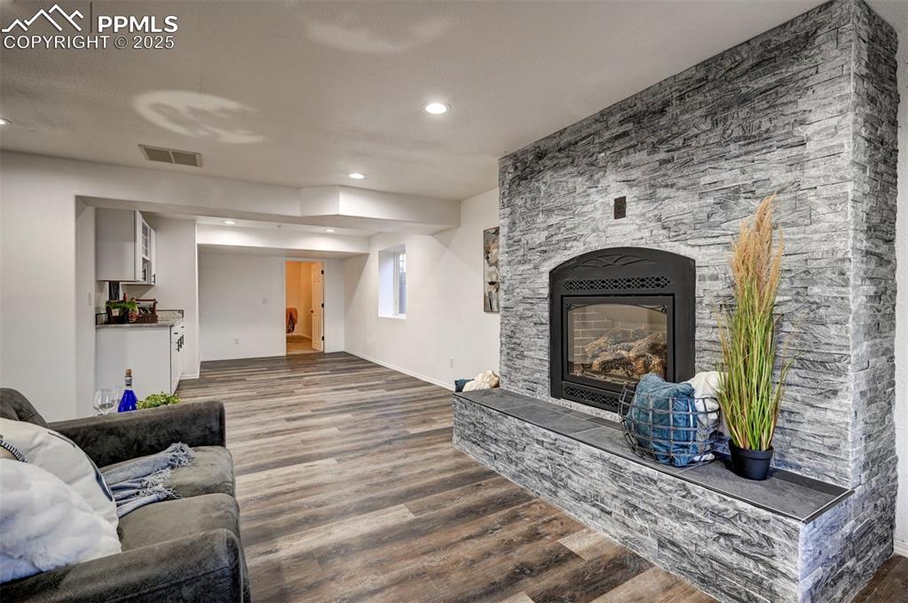 7790 Julynn Road Colorado Springs, CO 80919 - Photo 36 of 50 a living room with furniture and a fireplace