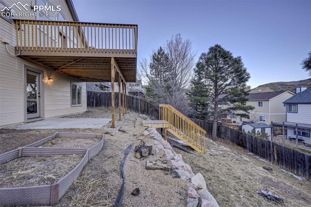 7790 Julynn Road Colorado Springs, CO 80919 - Photo 40 of 50 a view of a roof deck with wooden fence and a floor to ceiling window