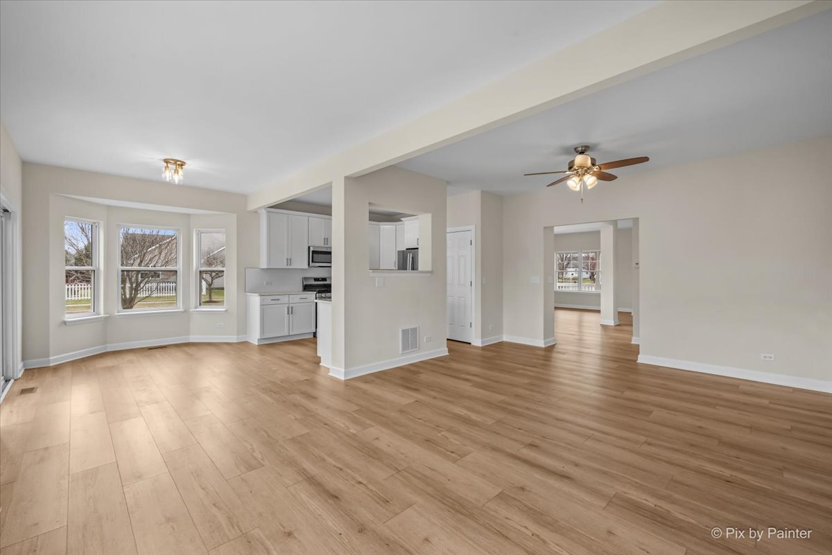 216 Winding Trail Genoa, IL 60135 - Photo 12 of 52 a view of empty room with wooden floor and window