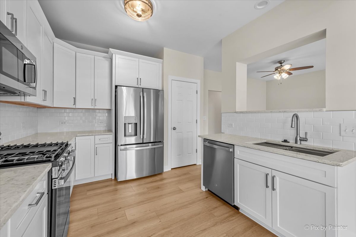 216 Winding Trail Genoa, IL 60135 - Photo 13 of 52 a kitchen with stainless steel appliances granite countertop a sink stove and refrigerator