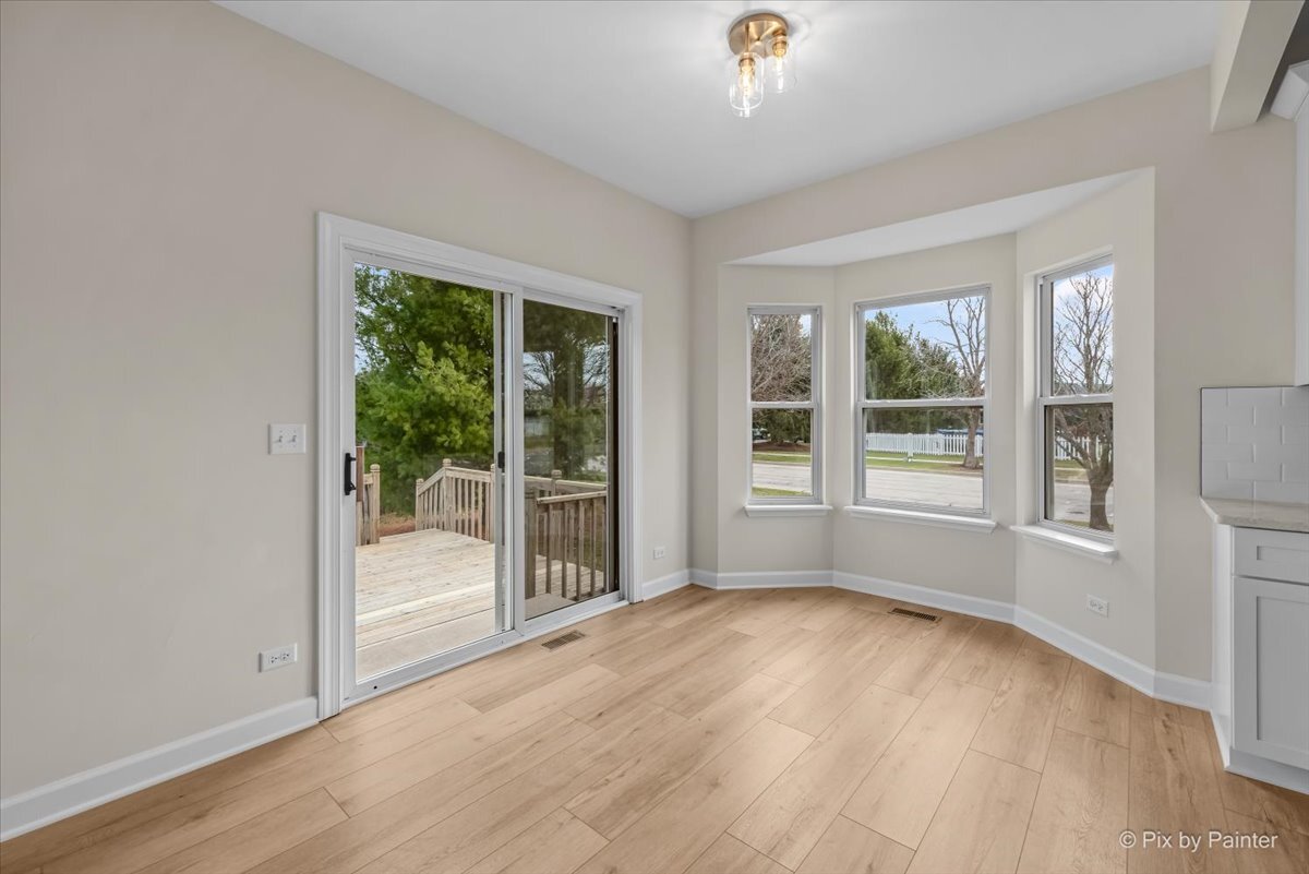 216 Winding Trail Genoa, IL 60135 - Photo 18 of 52 an empty room with wooden floor and windows