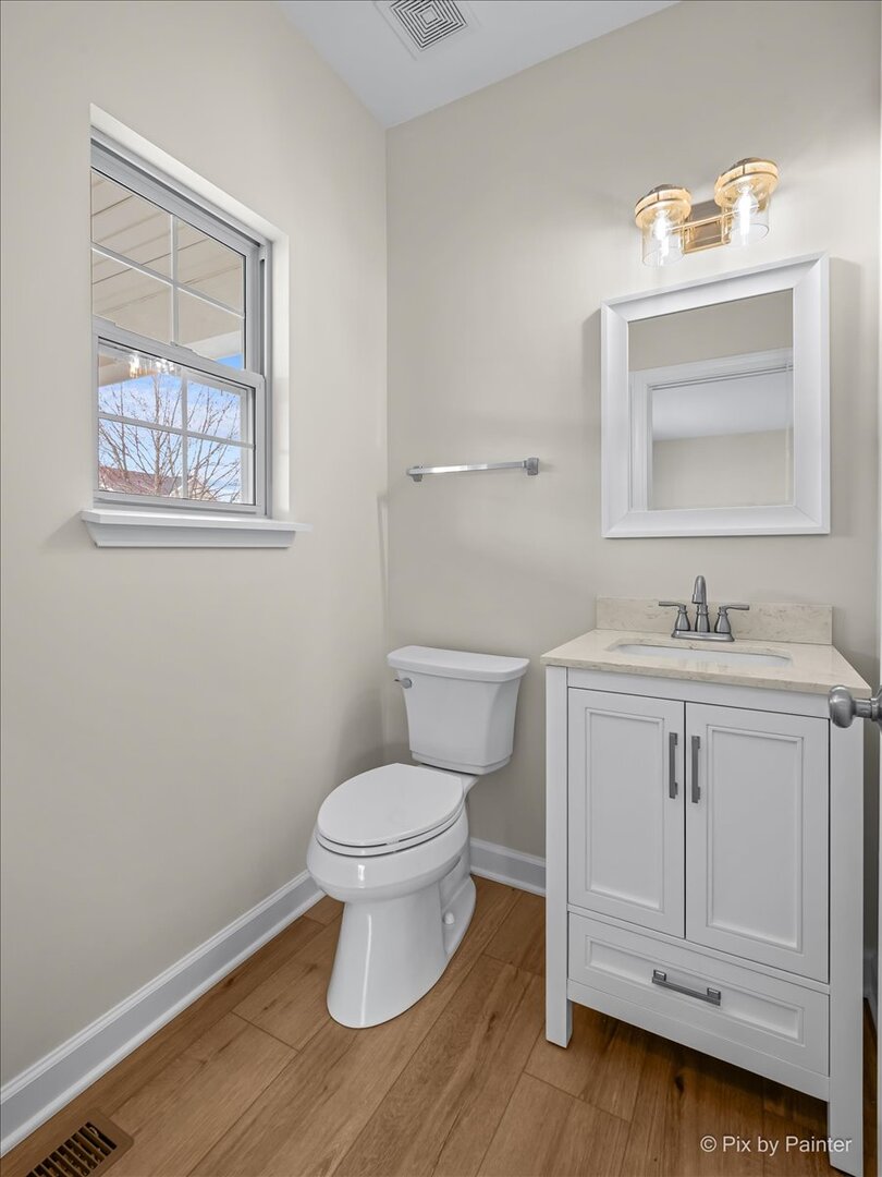 216 Winding Trail Genoa, IL 60135 - Photo 19 of 52 a bathroom with a toilet sink vanity and mirror