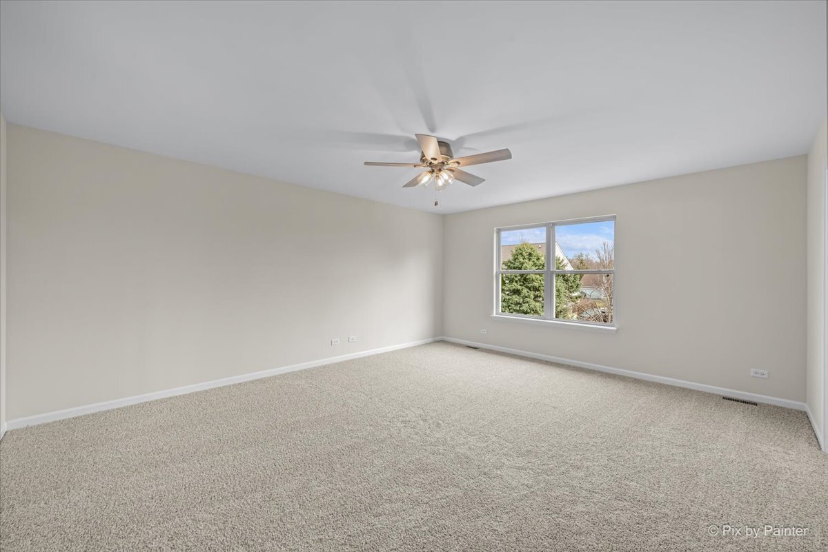 216 Winding Trail Genoa, IL 60135 - Photo 21 of 52 an empty room with windows and fan