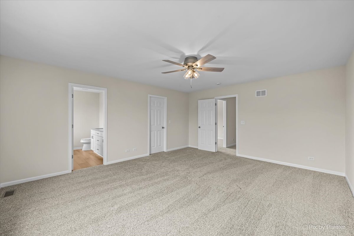 216 Winding Trail Genoa, IL 60135 - Photo 22 of 52 a view of an empty room with a ceiling fan