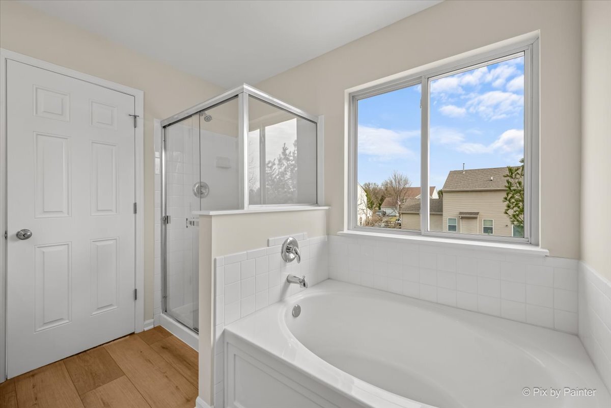 216 Winding Trail Genoa, IL 60135 - Photo 24 of 52 a bathroom with a bathtub and a shower