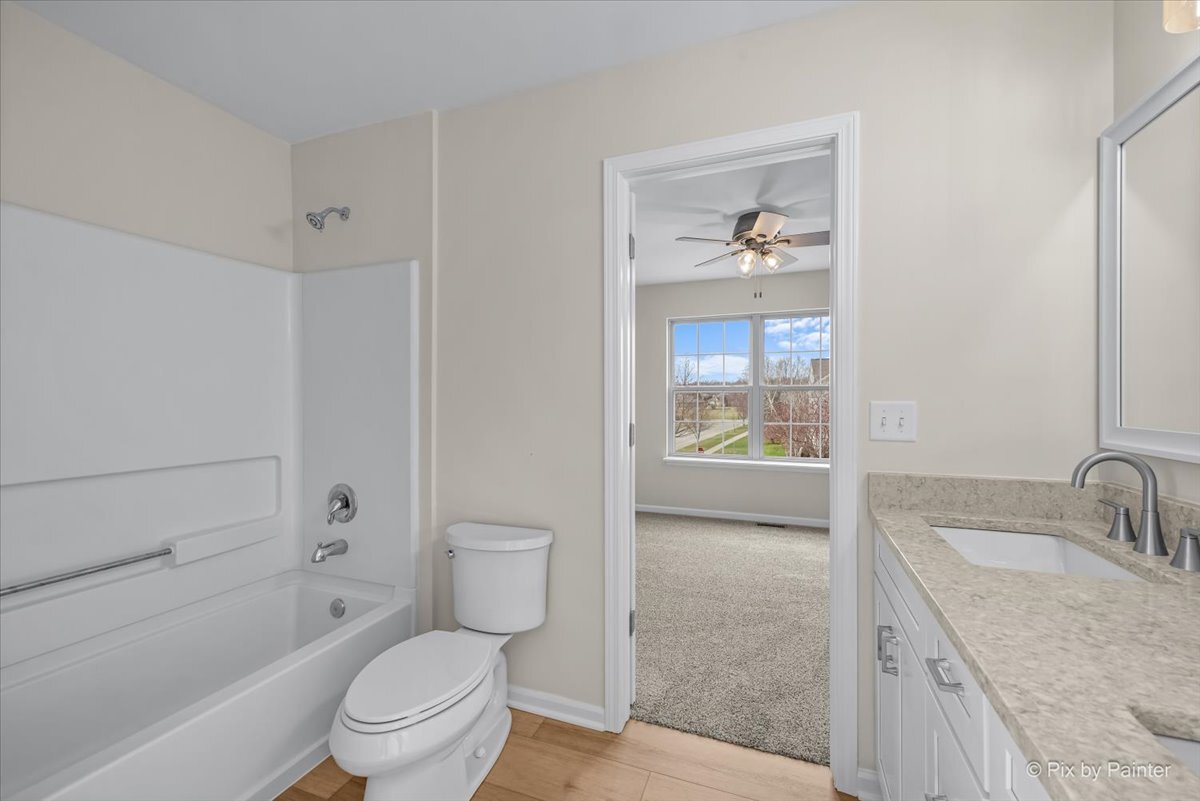 216 Winding Trail Genoa, IL 60135 - Photo 29 of 52 a bathroom with a granite countertop toilet a sink and a bathtub