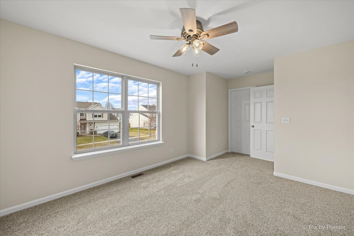 216 Winding Trail Genoa, IL 60135 - Photo 30 of 52 an empty room with windows and fan