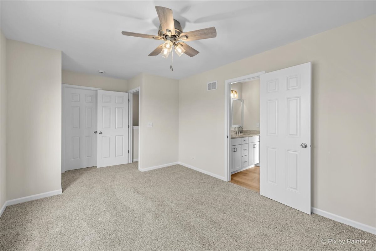 216 Winding Trail Genoa, IL 60135 - Photo 32 of 52 a view of an empty room with a ceiling fan