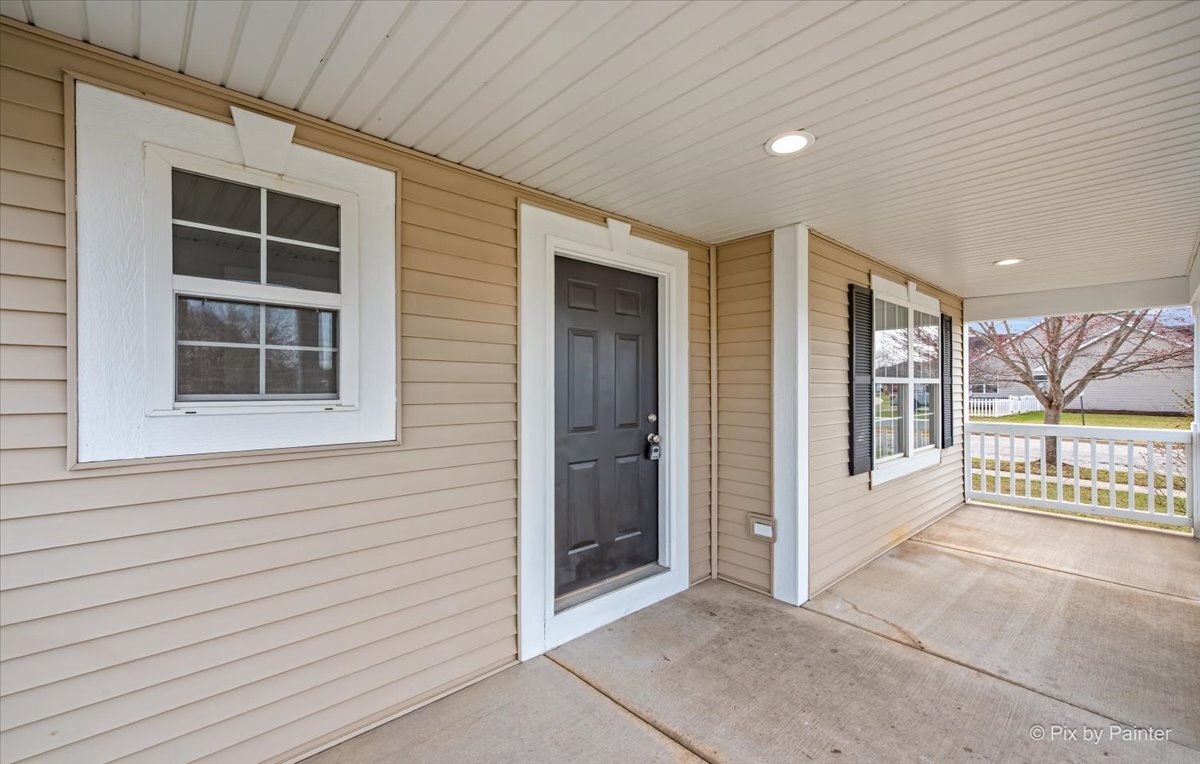216 Winding Trail Genoa, IL 60135 - Photo 4 of 52 a view of a porch with a door and wooden floor