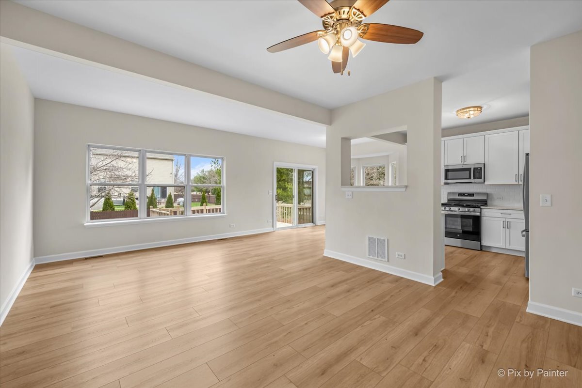 216 Winding Trail Genoa, IL 60135 - Photo 10 of 52 a view of an empty room with window and wooden floor