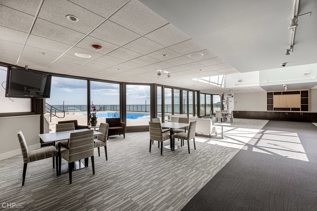 6007 North Sheridan Road, Unit 37J Chicago, IL 60660 - Photo 22 of 26 a view of a dining room with furniture window and wooden floor