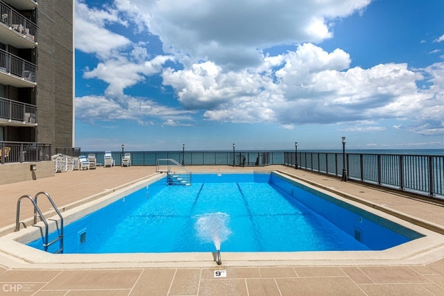 6007 North Sheridan Road, Unit 37J Chicago, IL 60660 - Photo 24 of 26 a view of a swimming pool with a lounge chair
