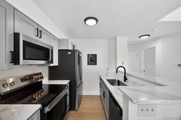 a kitchen with a sink and stainless steel appliances