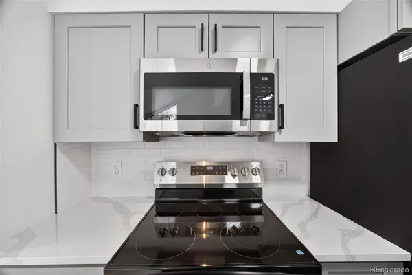 a kitchen with a stove and a microwave