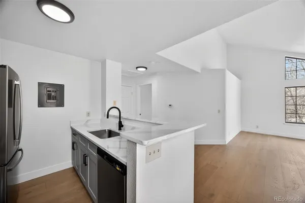 a kitchen with stainless steel appliances granite countertop a sink a stove and a refrigerator