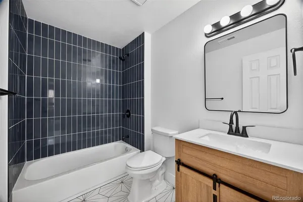 a bathroom with a sink toilet vanity and shower