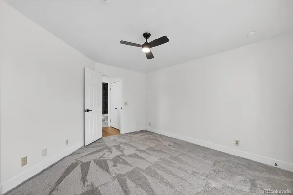 a view of a room with a ceiling fan