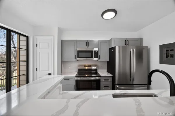 a kitchen with a refrigerator and a sink