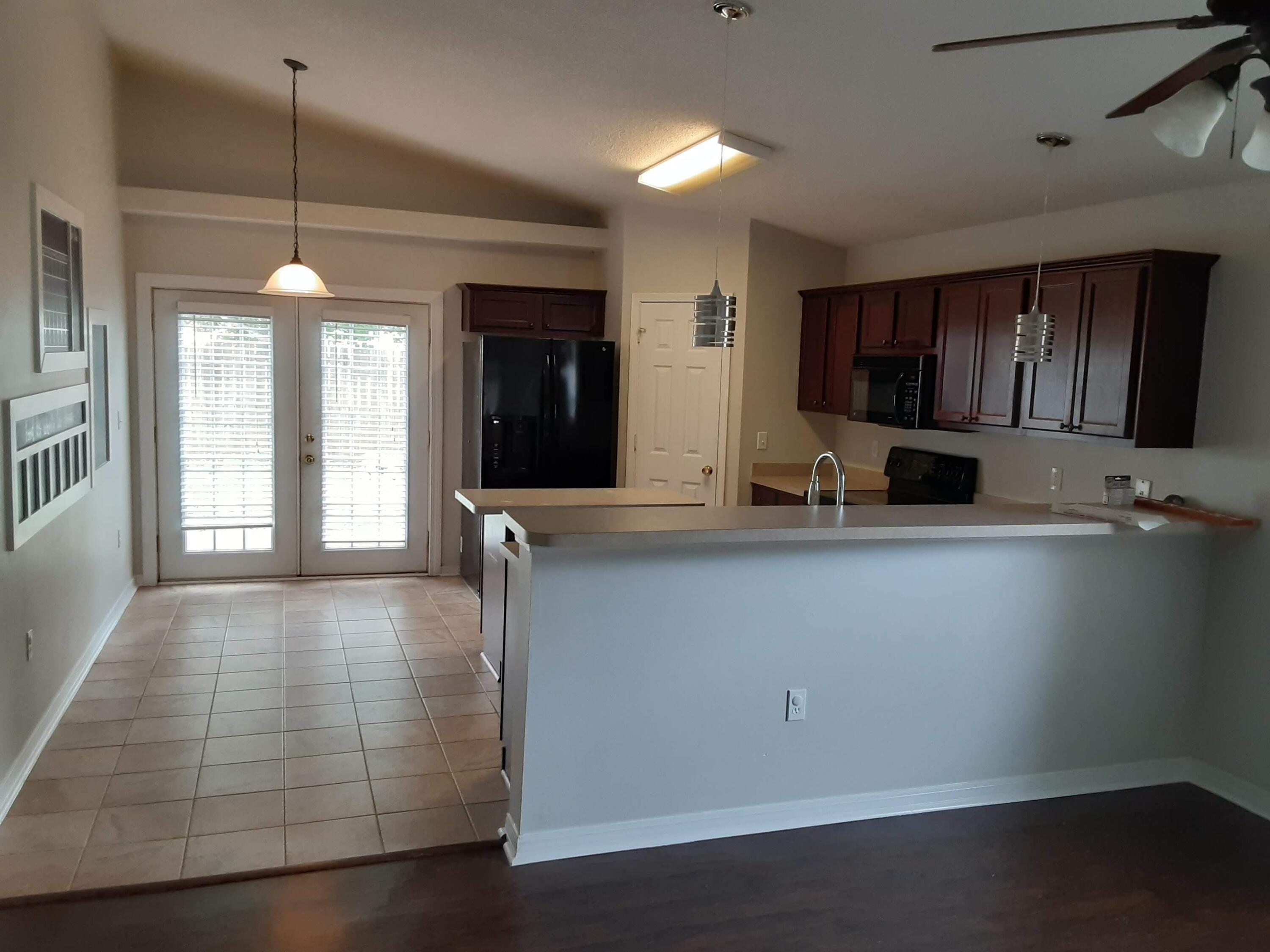 237 Limestone Circle Crestview, FL 32539 - Photo 11 of 15 a kitchen with kitchen island a counter top space a sink and appliances