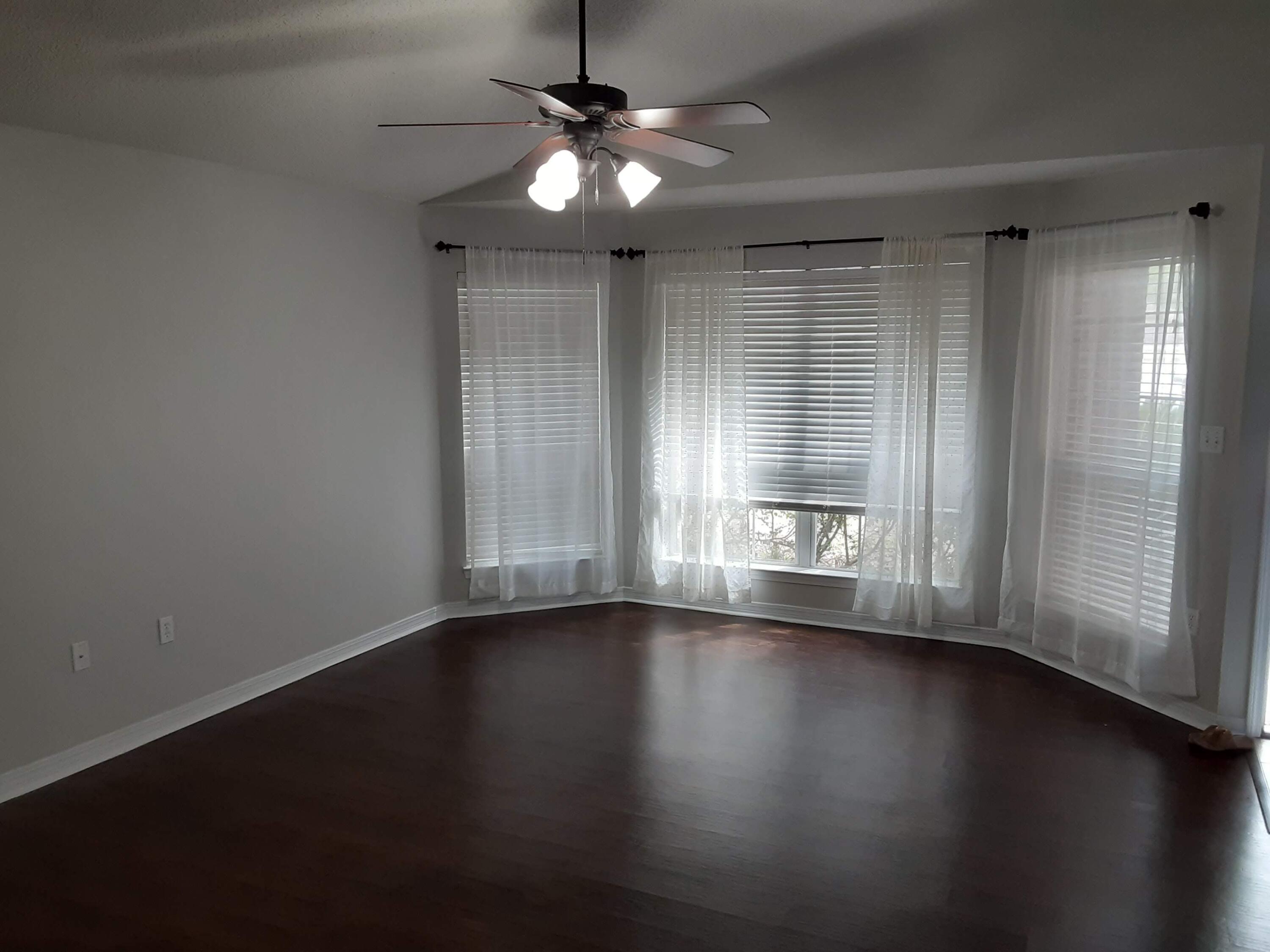 237 Limestone Circle Crestview, FL 32539 - Photo 3 of 15 an empty room with wooden floor and windows