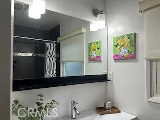 a bathroom with a toilet a sink and a mirror