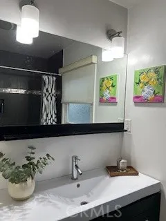 a view of a patio with table and chairs potted plants with floor to ceiling window