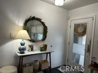 a patio with a table and chairs and potted plants