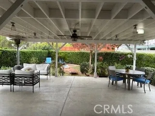 a view of a patio with a table and chairs under an umbrella