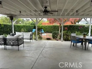 a view of a chairs and table in the garden