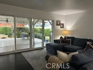 a living room with furniture and a floor to ceiling window