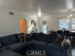a living room with furniture a lamp and a window