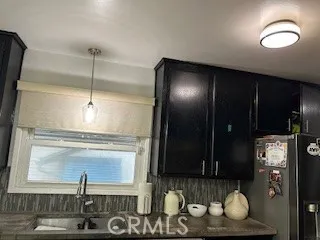 a kitchen with a sink and a refrigerator
