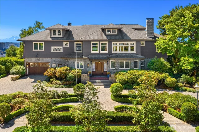 a front view of a residential houses with yard