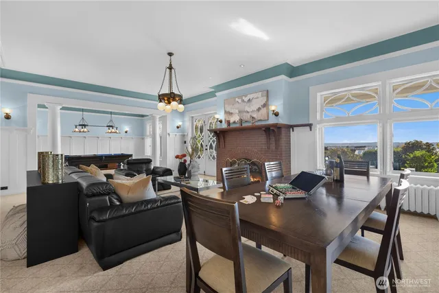 a dining room with furniture a chandelier and window