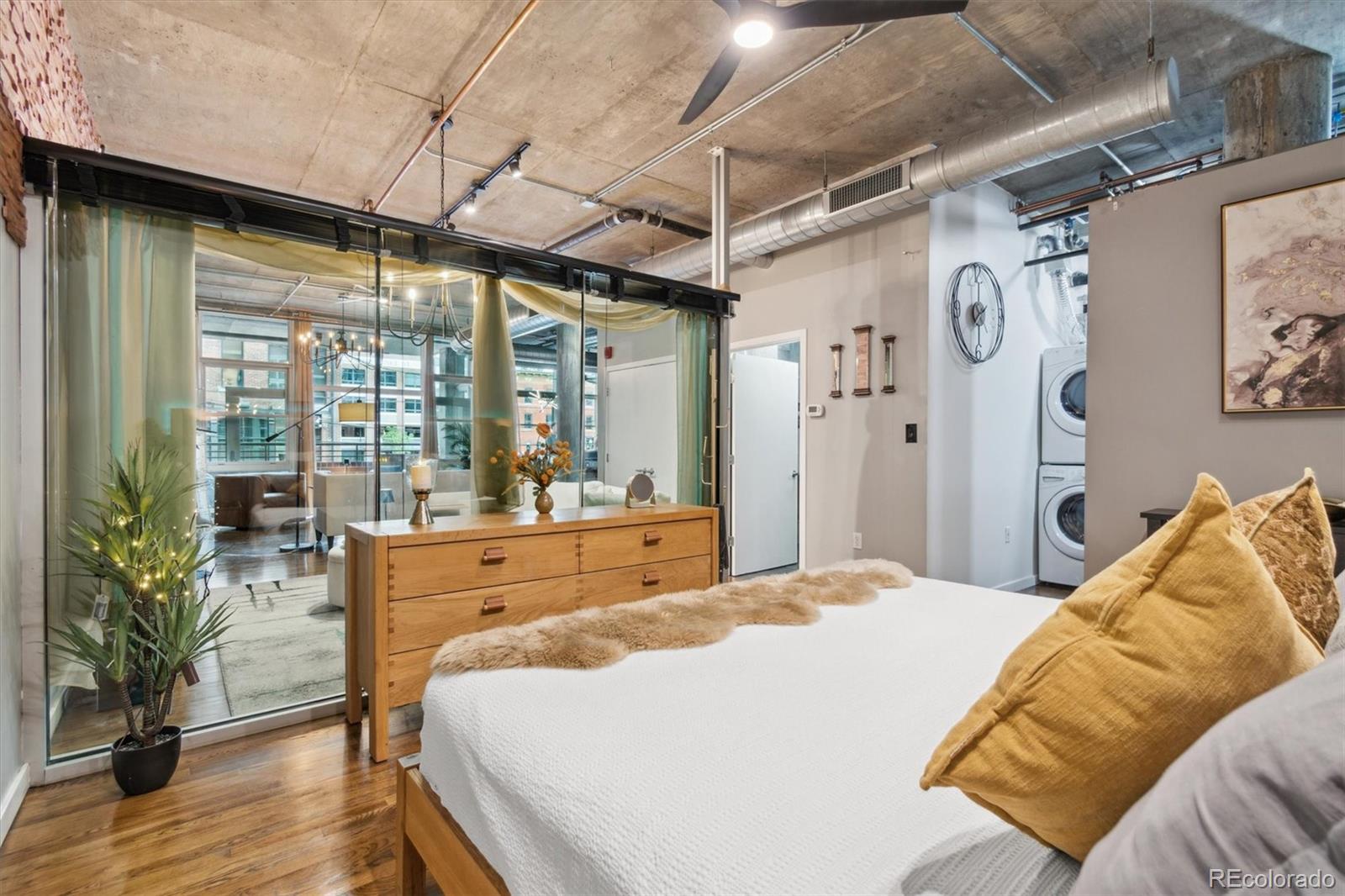 1720 Wazee Street, Unit 2B Denver, CO 80202 - Photo 13 of 17 a bed sitting in a bedroom next to a window