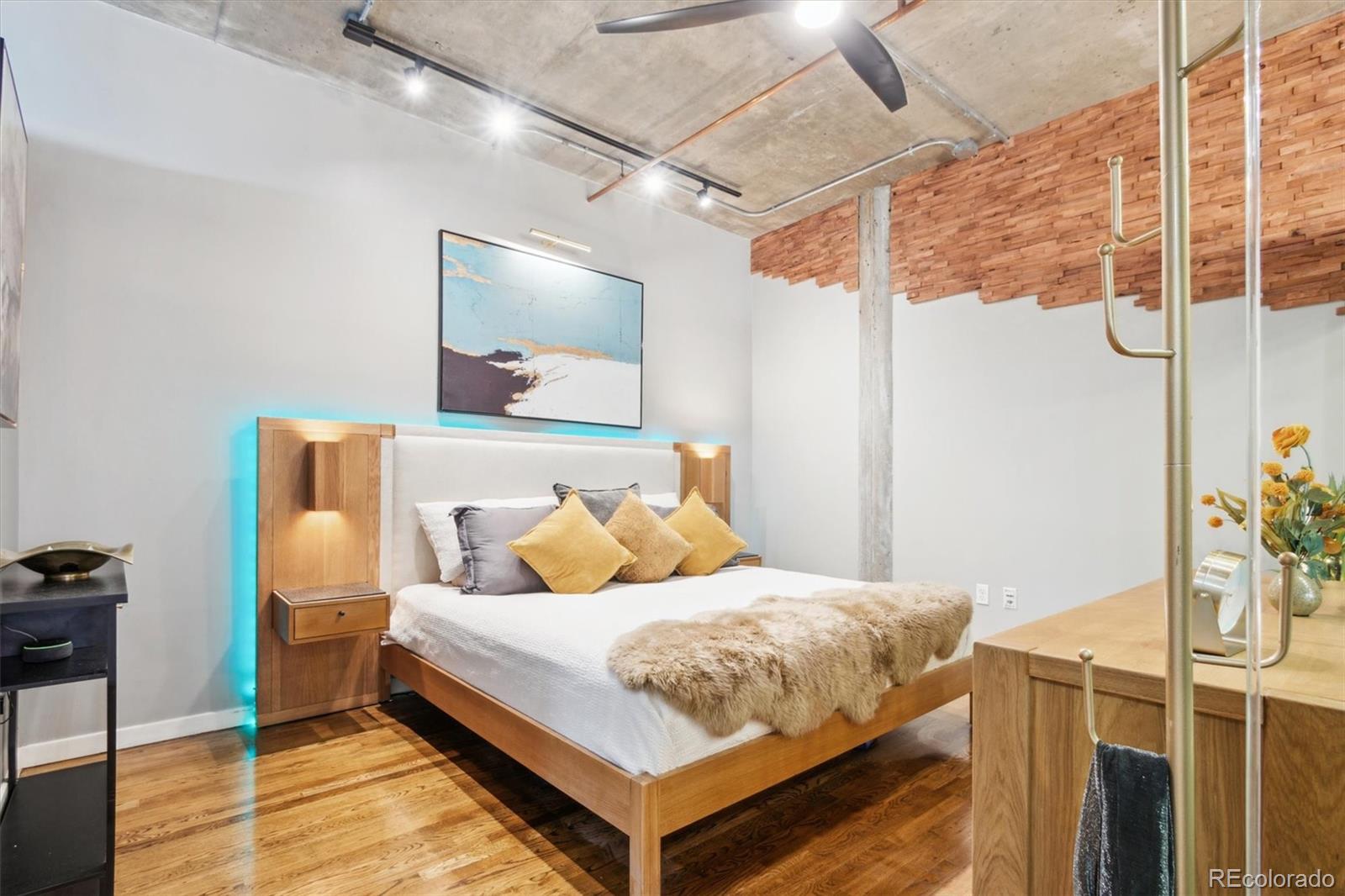 1720 Wazee Street, Unit 2B Denver, CO 80202 - Photo 14 of 17 a bedroom with a bed and wooden floor