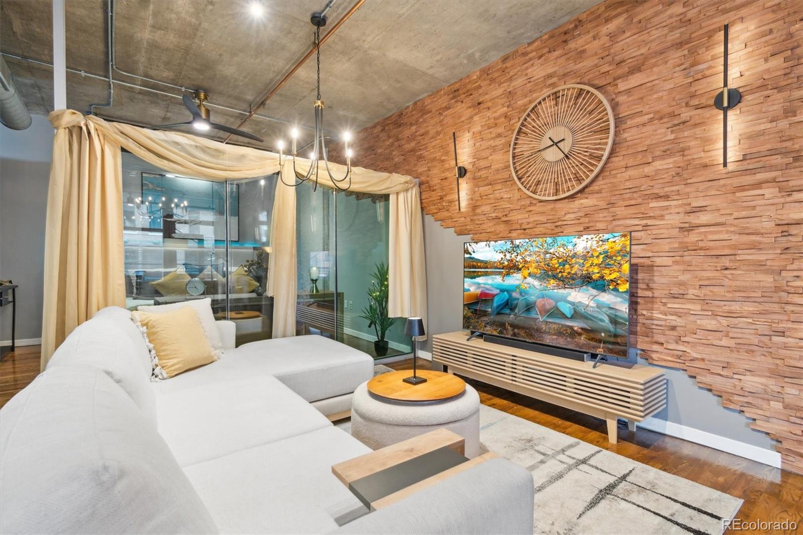 1720 Wazee Street, Unit 2B Denver, CO 80202 - Photo 3 of 17 a bedroom with furniture and a flat screen tv