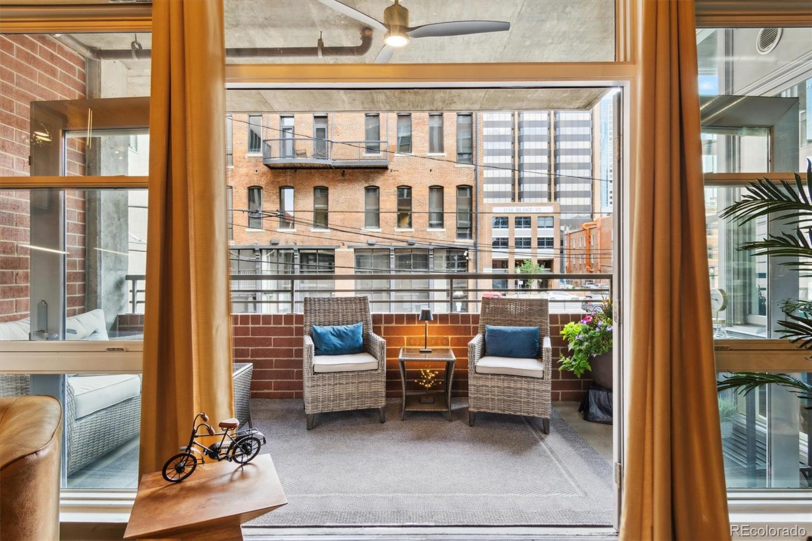1720 Wazee Street, Unit 2B Denver, CO 80202 - Photo 7 of 17 a balcony view with couple of couch and a potted plant
